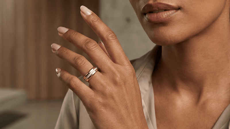 Close-up of a hand wearing a fashion smart ring with a blurred background